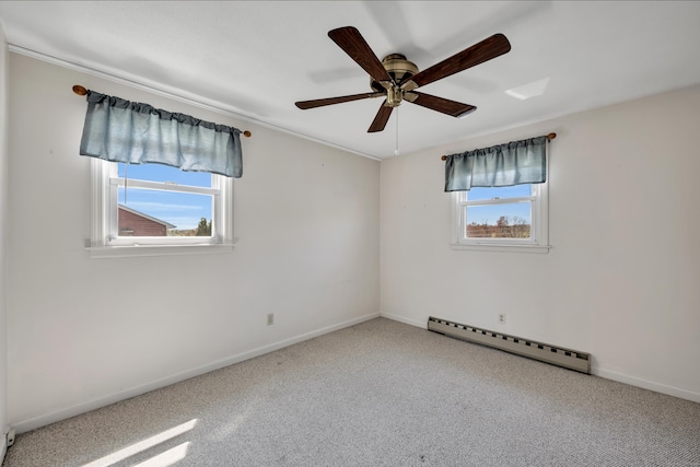 carpeted empty room with baseboards, a baseboard radiator, and ceiling fan