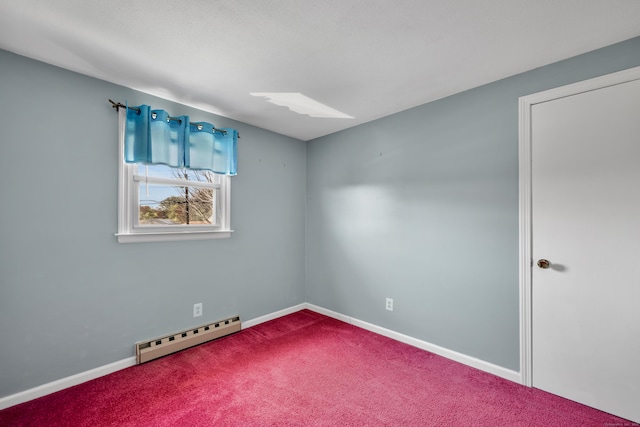 spare room with a skylight, baseboards, carpet, and a baseboard radiator