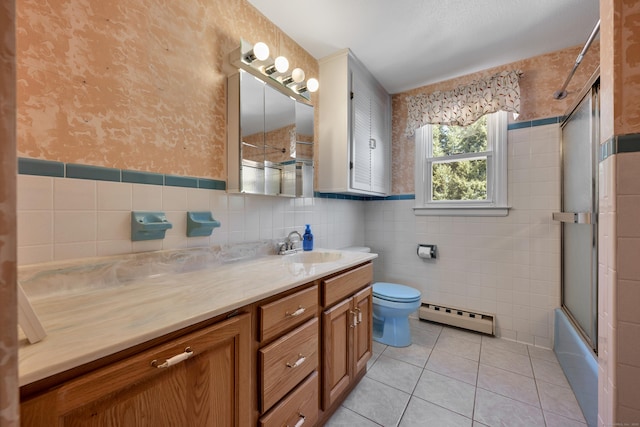 bathroom featuring toilet, tile walls, baseboard heating, wallpapered walls, and tile patterned floors