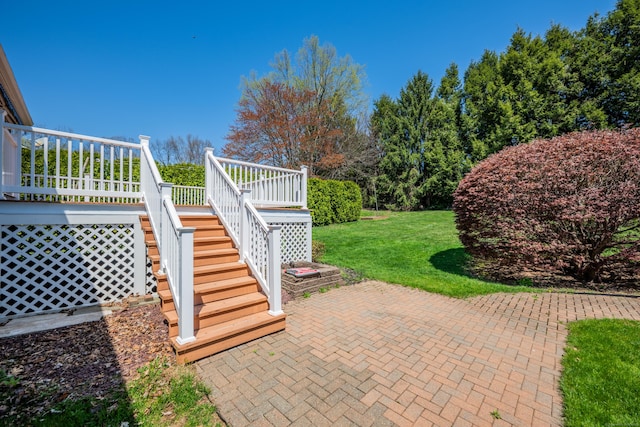 view of patio / terrace featuring a wooden deck and stairs