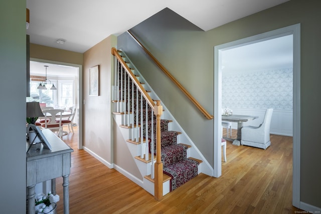 114 Cobbler Ln, Southbury, CT 06488 - stairs featuring baseboards, wallpapered walls, and wood finished floors