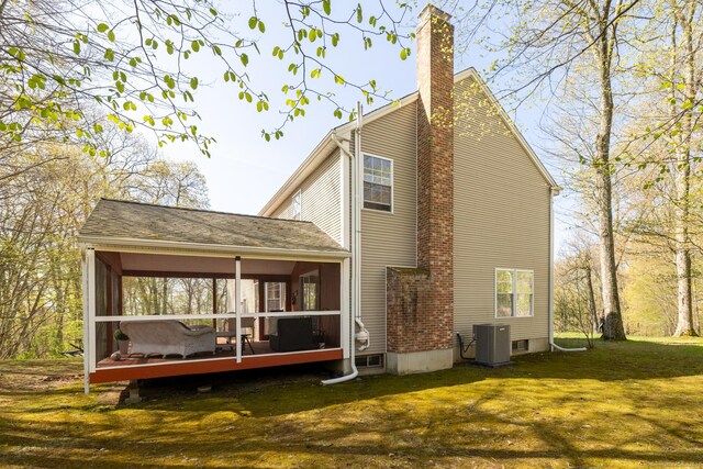 114 Cobbler Ln, Southbury, CT 06488 - rear view of house featuring a chimney, a lawn, a wooden deck, a sunroom, and central air condition unit