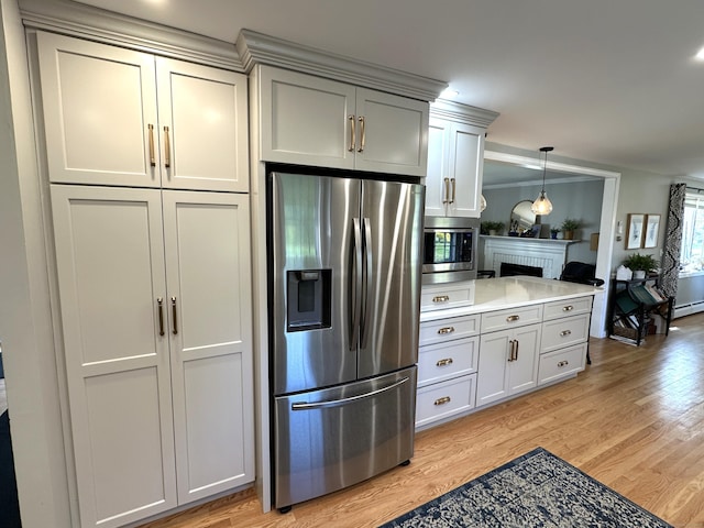 kitchen featuring gray cabinets, a brick fireplace, stainless steel appliances, and light wood-style floors