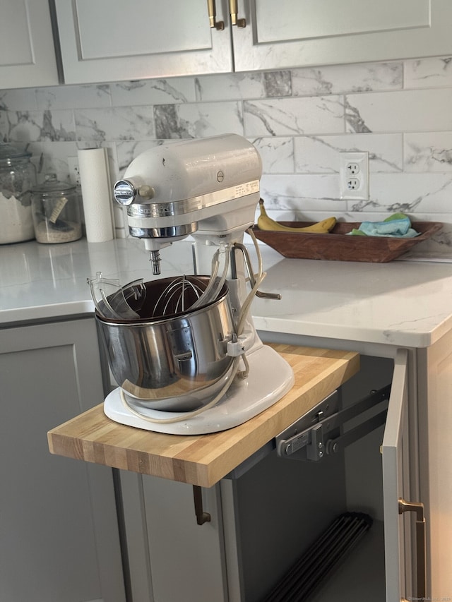 interior details featuring decorative backsplash and wooden counters