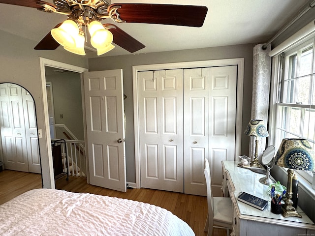 bedroom with a closet, a ceiling fan, and wood finished floors