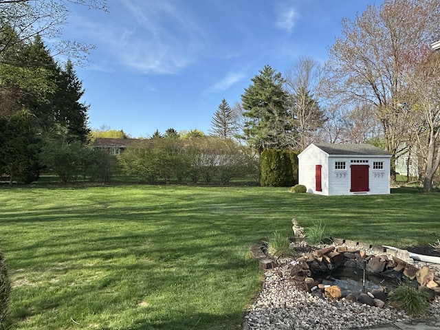 view of yard with a fire pit and an outbuilding
