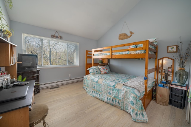 bedroom with baseboard heating, wood finished floors, and lofted ceiling