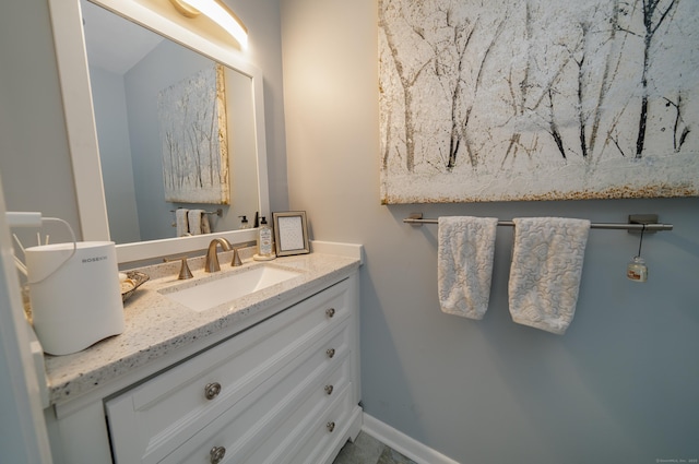 bathroom featuring baseboards and vanity