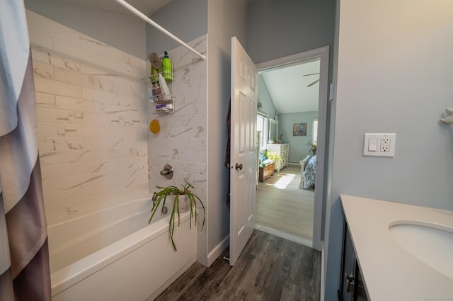 full bath featuring vanity, baseboards, shower / bath combo with shower curtain, and wood finished floors
