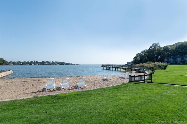 dock area featuring a lawn and a water view
