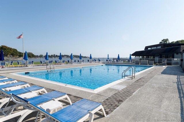 pool with fence and a patio area