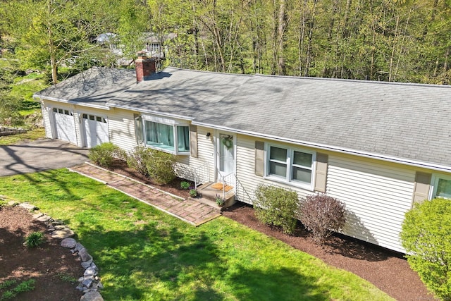 82 Village Dr, Shelton, CT 06484 - ranch-style home featuring aphalt driveway, a front yard, a chimney, a shingled roof, and an attached garage
