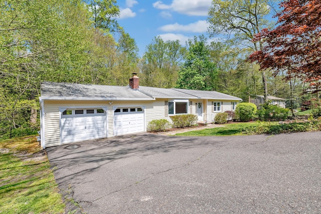 82 Village Dr, Shelton, CT 06484 - ranch-style house featuring an attached garage, a chimney, and driveway