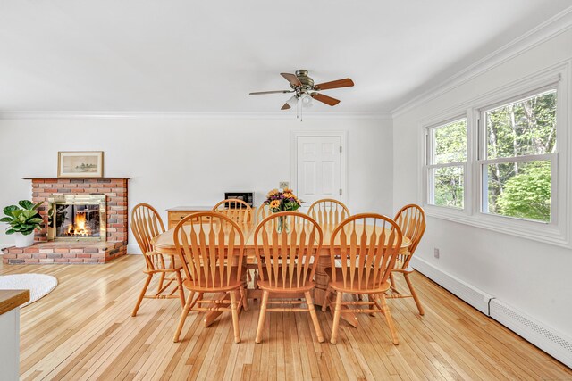 82 Village Dr, Shelton, CT 06484 - dining space with a ceiling fan, ornamental molding, baseboard heating, and hardwood / wood-style flooring