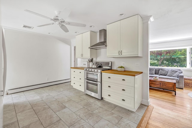 82 Village Dr, Shelton, CT 06484 - kitchen with a ceiling fan, double oven range, a baseboard heating unit, butcher block counters, and wall chimney exhaust hood