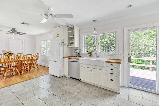 82 Village Dr, Shelton, CT 06484 - kitchen with a sink, wooden counters, freestanding refrigerator, stainless steel dishwasher, and visible vents