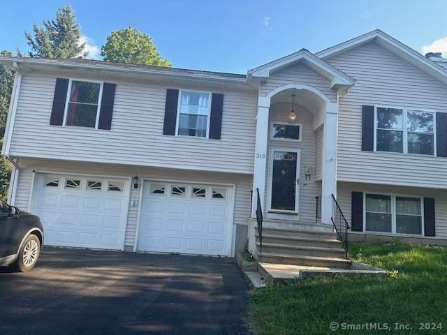 bi-level home with an attached garage and driveway