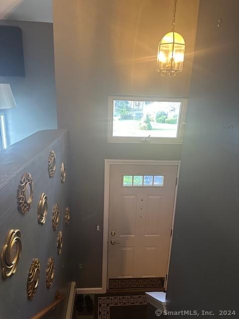 entryway with an inviting chandelier