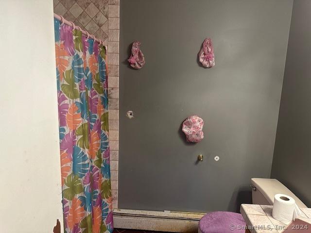 bathroom featuring toilet and a shower with shower curtain