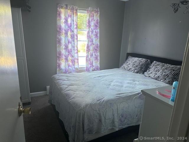 carpeted bedroom featuring baseboards