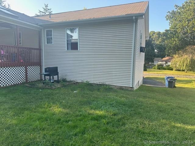 view of property exterior with a lawn