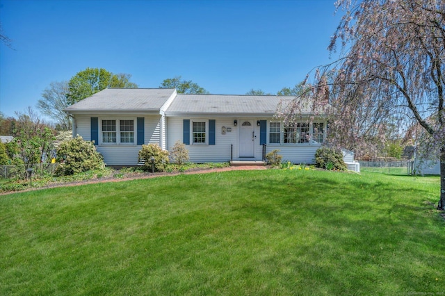 single story home featuring fence, a chimney, and a front yard