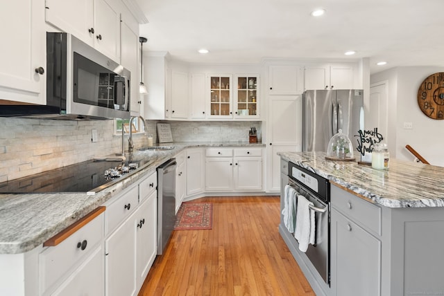 kitchen with white cabinets, stainless steel appliances, and a sink