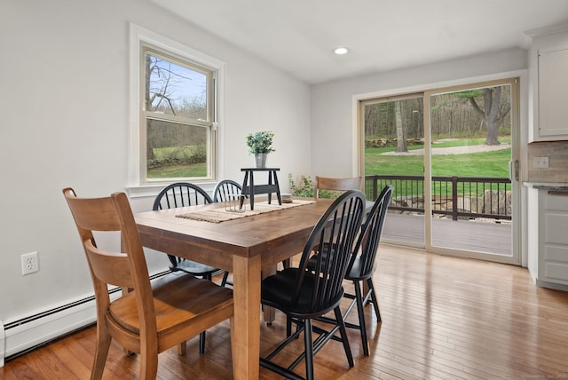 dining space with recessed lighting and light wood-style flooring