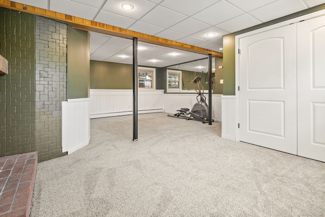 basement with recessed lighting, carpet, a wainscoted wall, and baseboard heating