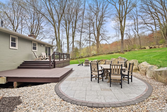 view of patio with outdoor dining area and a wooden deck