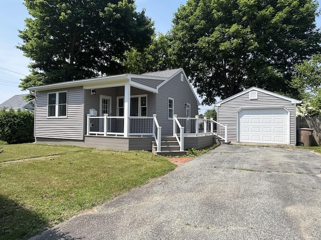 14 N Washington Ave, East Lyme, CT 06357 - view of front facade with an outbuilding, a garage, a front lawn, asphalt driveway, and covered porch