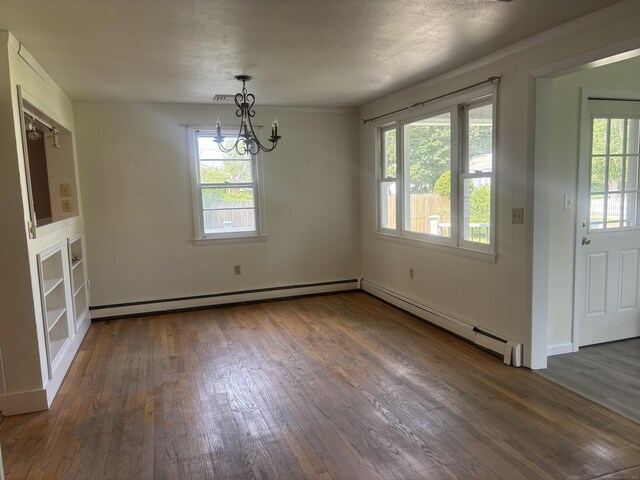 14 N Washington Ave, East Lyme, CT 06357 - unfurnished dining area with baseboard heating, dark wood finished floors, and a chandelier