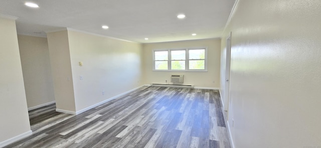 empty room featuring crown molding, recessed lighting, baseboards, and wood finished floors