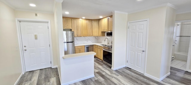 kitchen with light wood-style floors, appliances with stainless steel finishes, and crown molding