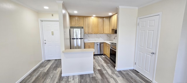kitchen featuring crown molding, appliances with stainless steel finishes, light countertops, baseboards, and light wood-style flooring