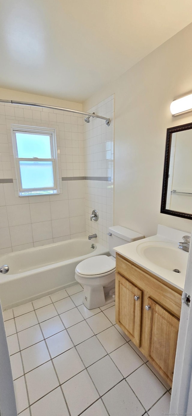 bathroom featuring tile patterned floors, vanity, toilet, and shower / tub combination