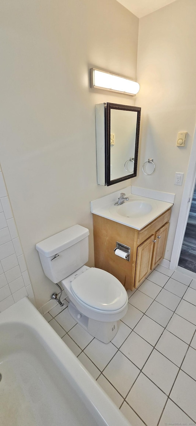 bathroom featuring toilet, tile patterned floors, and vanity