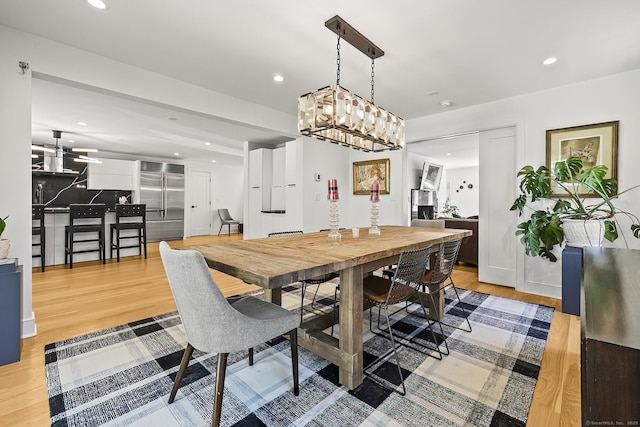dining area featuring light wood-style floors and recessed lighting