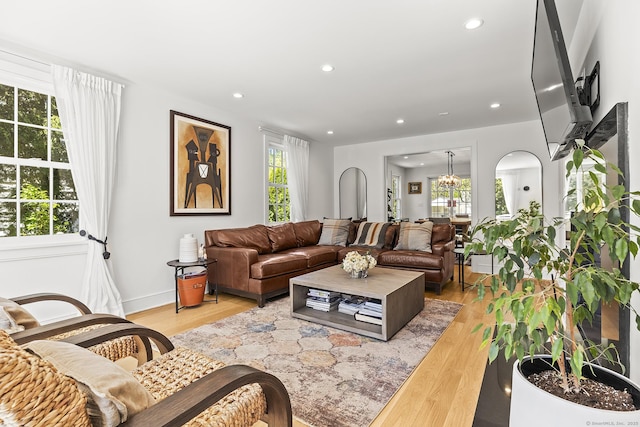 living room featuring light wood-style floors, recessed lighting, and baseboards