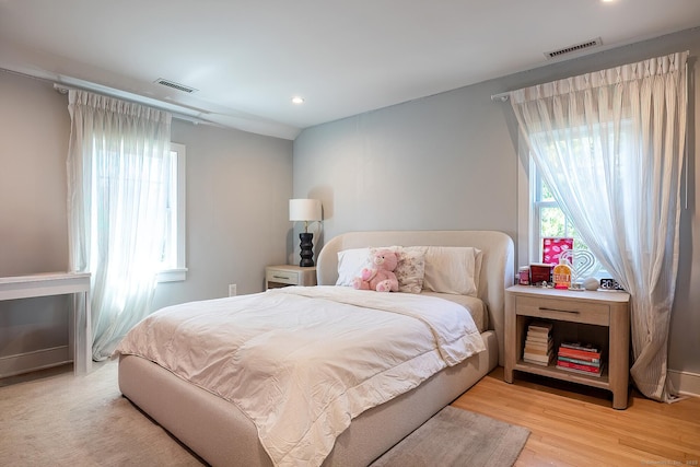 bedroom with light wood-type flooring, recessed lighting, and visible vents