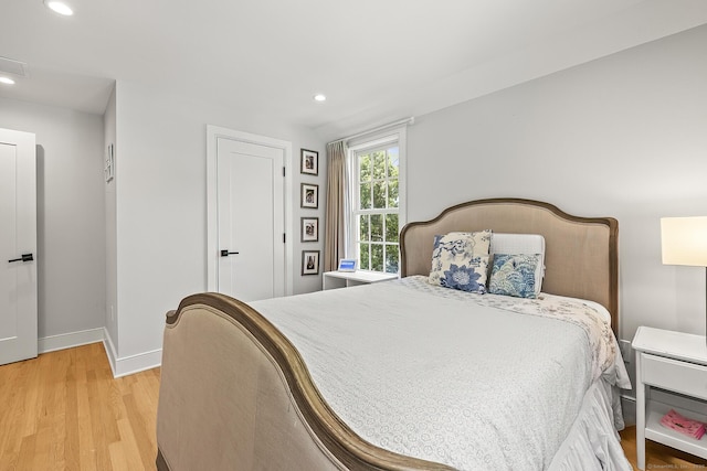 bedroom with recessed lighting, baseboards, and light wood-type flooring