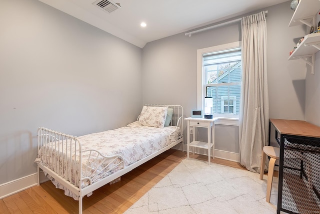 bedroom featuring baseboards, recessed lighting, wood finished floors, and visible vents