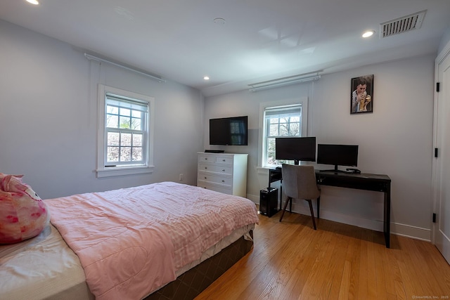 bedroom with recessed lighting, visible vents, multiple windows, and light wood-style floors