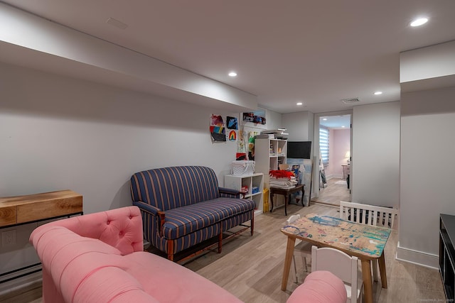 living room featuring recessed lighting, light wood finished floors, and visible vents