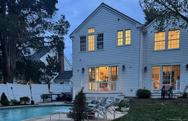 back of house with a fenced in pool, a patio area, fence, and a yard