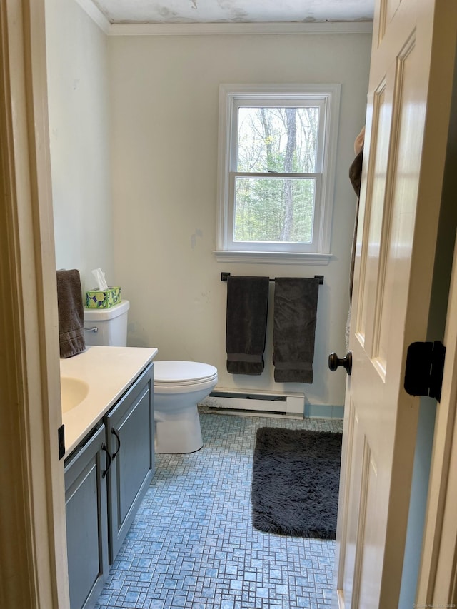 half bathroom featuring vanity, toilet, ornamental molding, and a baseboard heating unit