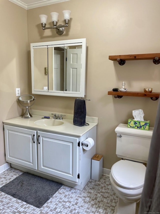 half bath with vanity, toilet, ornamental molding, and baseboards