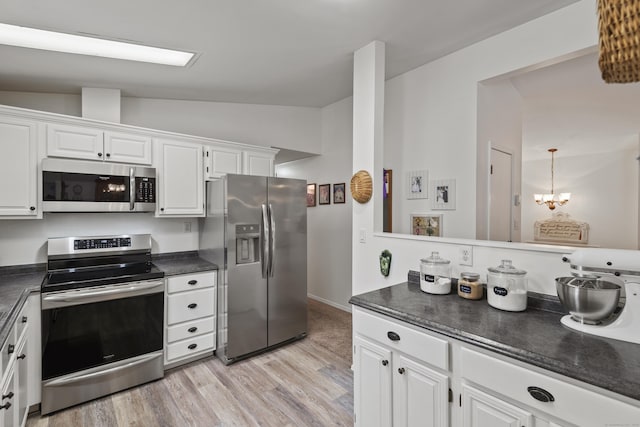 kitchen with stainless steel appliances, dark countertops, light wood-style floors, and lofted ceiling