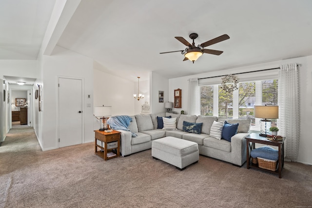 living room featuring ceiling fan with notable chandelier and carpet floors