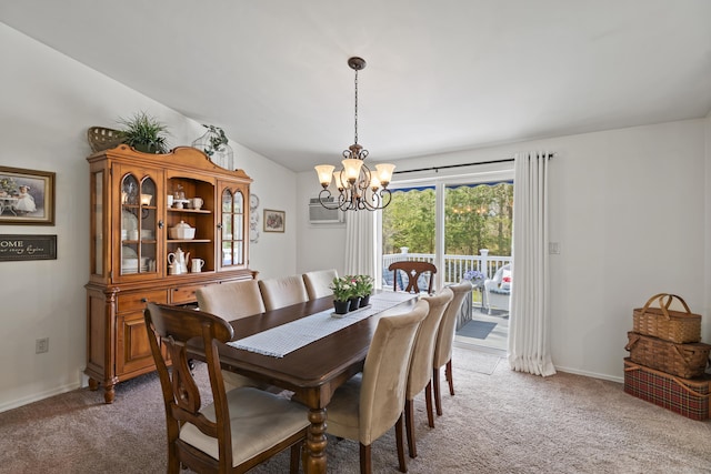dining room with a wall unit AC, a notable chandelier, baseboards, and light carpet
